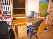 Arbeitszimmer mit Schreibtisch und Regalen aus Holz